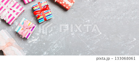 Top view of Christmas background made of gift boxes on cement background. New year holiday concept with copy space Top view of Christmas background made of gift boxes on cement background. New year holiday concept with copy space 133068061