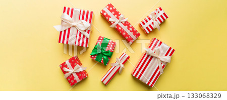 A lot of Christmas gift boxes in colored paper decorated on table, Top view close up. Many present New Year gift A lot of Christmas gift boxes in colored paper decorated on table, Top view close up. Many present New Year gift 133068329