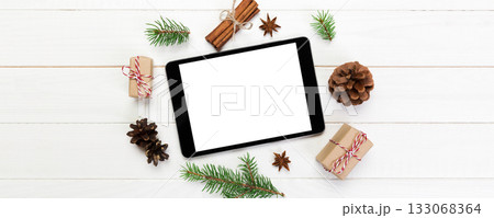 Digital tablet mock up with rustic Christmas wooden background decorations for app presentation. top view with copy space 133068364