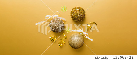 Christmas ball on colored background. decoration bauble with ribbon bow with copy space 133068422