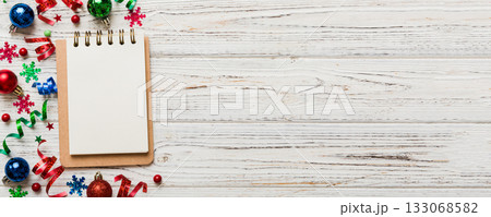 Christmas blank greeting card mock-up scene. Creative layout made of Christmas tree branches and paper card note. Flat lay. Nature New Year concept Christmas blank greeting card mock-up scene. Creative layout made of Christmas tree branches and paper card note. Flat lay. Nature New Year concept 133068582