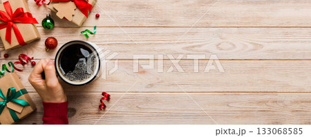 Woman holding cup of coffee. Woman hands holding a mug with hot coffee. Winter and Christmas time concept 133068585
