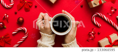 Woman holding cup of coffee. Woman hands holding a mug with hot coffee. Winter and Christmas time concept 133068595