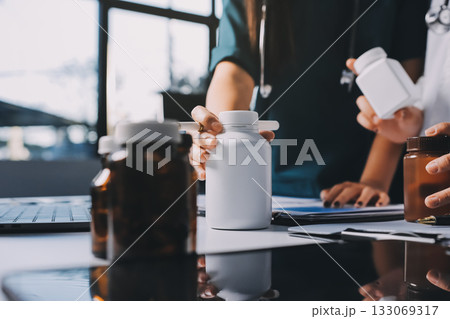 Group of doctors attending seminar in hospital lecture hall with senior physician giving medical presentation and professional training session on healthcare practices 133069317