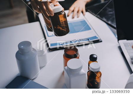 Group of doctors attending seminar in hospital lecture hall with senior physician giving medical presentation and professional training session on healthcare practices 133069350