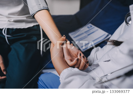 Nurse measuring blood pressure of elderly woman at table, closeup. Assisting senior generation 133069377