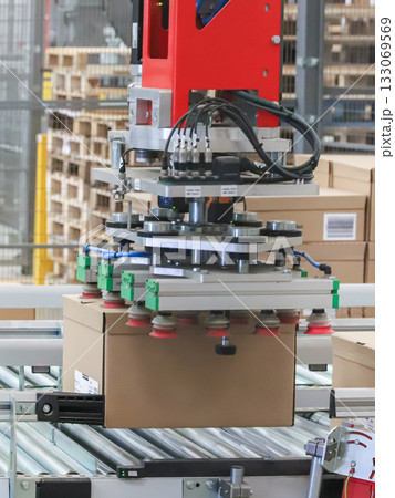 packing line in a logistics warehouse. conveyor belt in a modern production line packing line in a logistics warehouse. conveyor belt in a modern production line 133069569