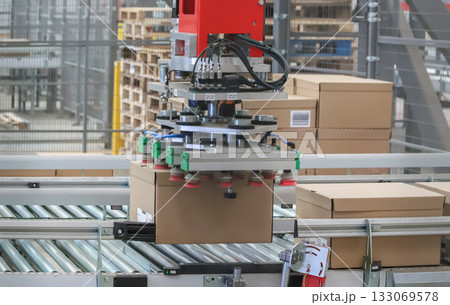 packing line in a logistics warehouse. conveyor belt in a modern production line packing line in a logistics warehouse. conveyor belt in a modern production line 133069578