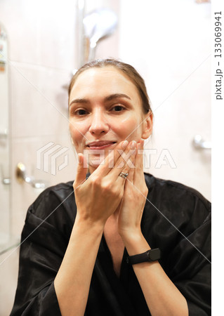 Woman Applying Face Cream, Bathroom Routine Woman Applying Face Cream, Bathroom Routine 133069941