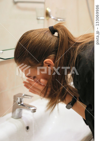 Woman Washing Face In Bathroom Sink Woman Washing Face In Bathroom Sink 133069986
