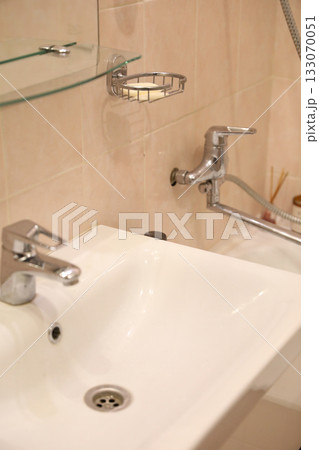 Bright Bathroom Sink and Fixtures Detail 133070051