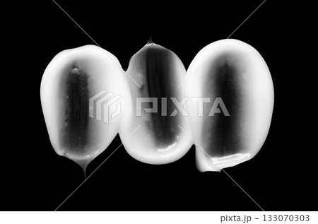 A sample of white body cosmetics on a black background A sample of white body cosmetics on a black background 133070303