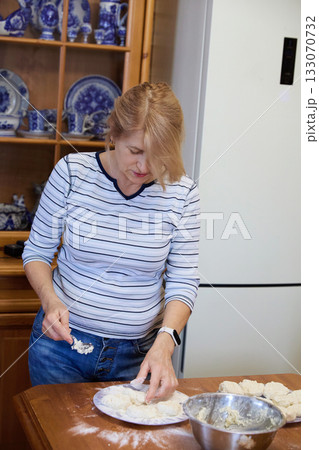 Senior Woman Cooking Pancakes at Home 133070732