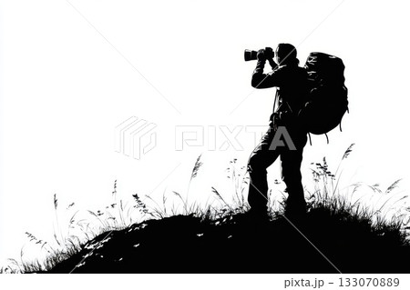 Silhouette of a photographer capturing nature at sunset on a hill with a backpack Silhouette of a photographer capturing nature at sunset on a hill with a backpack 133070889