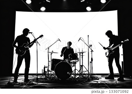Silhouette of a live band performing on stage with dramatic lighting during a music event at a local venue in the evening Silhouette of a live band performing on stage with dramatic lighting during a music event at a local venue in the evening 133071092