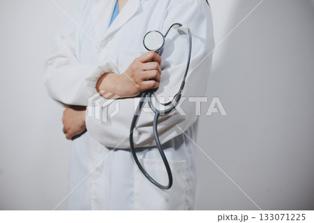 A young male doctor holding an stethoscope A young male doctor holding an stethoscope 133071225