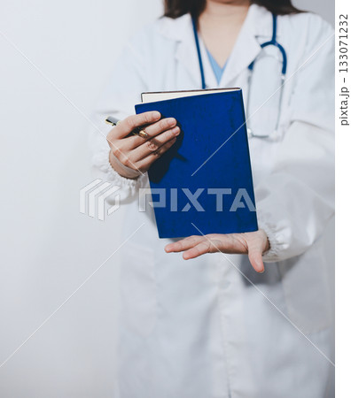 Portrait of female doctor, holding file 133071232