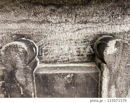 Ancient rocks. The throne is carved into the rocks. The texture of the stone wall. Ancient rocks. The throne is carved into the rocks. The texture of the stone wall. 133071576