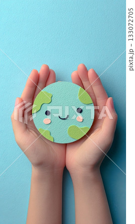Hands Holding a Smiling Earth Model on Blue Background 133072705
