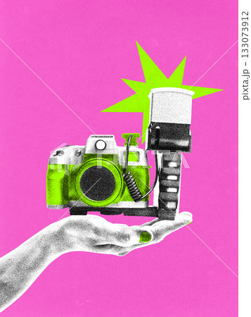 Pop art collage. Retro camera with flash balanced on hand in vibrant photocopy style. 133073912