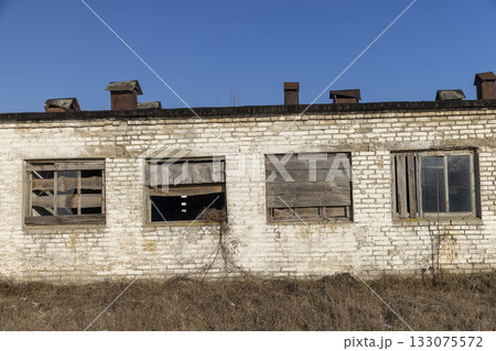 an old abandoned building made of brick in the winter, an abandoned building intended for demolition, the entrances and windows to the building are boarded up an old abandoned building made of brick in the winter, an abandoned building intended for demolition, the entrances and windows to the building are boarded up 133075572