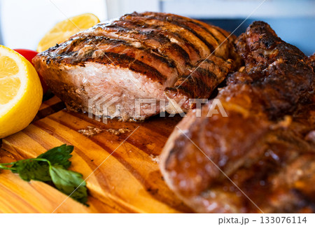 Horizontla close- up of various cuts of grilled meat ready to eat, creating a tempting and traditional culinary experience.Perfect for gourmet cooking advertisements. 133076114