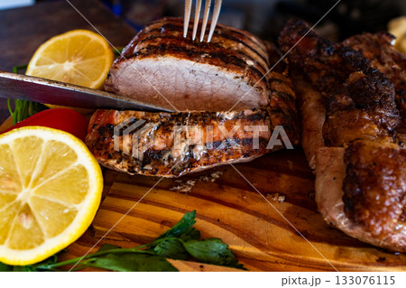 Horizontal close up of grilled beef steaks on a wooden board. Healthy and delicious traditional Argentinean food.Perfect for gourmet cooking advertisements. 133076115