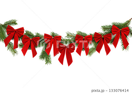 Elegant pine and fir christmas swag adorned with classic red velvet ribbons, evoking traditional holiday spirit and cozy winter celebrations 133076414