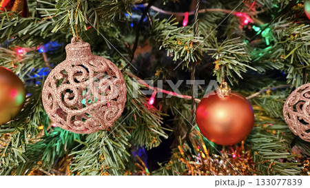 Christmas tree branches with beautiful balls and lights Christmas tree branches with beautiful balls and lights 133077839