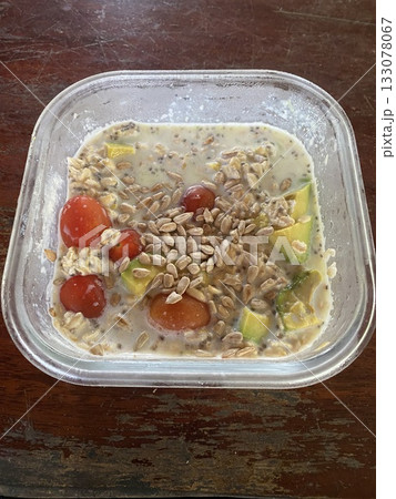 Close up view of delicious food, oatmeal porridge with fresh fruits and vegetables in a glass container, healthy food take away in boxes, diet concept 133078067