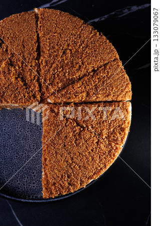 Layered Crumb Cake With Cream Filling On Dark Plate 133079067