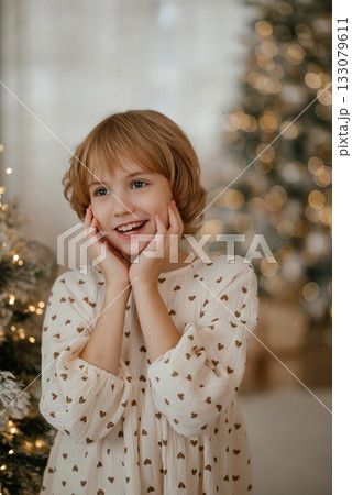 Happy Child Excited by Christmas Tree with Lights Happy Child Excited by Christmas Tree with Lights 133079611