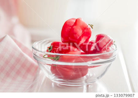 Red chili pepper habanero in bowl on white table. 133079907
