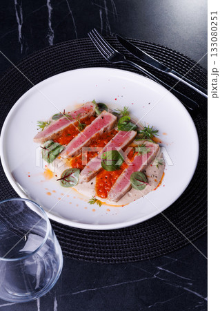 Seared Tuna Steak Slices on Creamy Sauce with Fresh Greens Seared Tuna Steak Slices on Creamy Sauce with Fresh Greens 133080251
