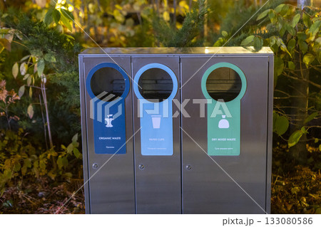 Modern glossy metal trash can. Waste sorting. Green concept. Modern glossy metal trash can. Waste sorting. Green concept. 133080586