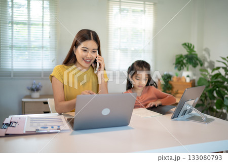 Lovely mom and little young daughter spending time together in their living room. 133080793