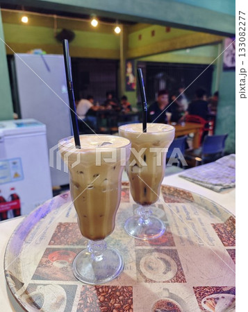 Two Glasses of Iced Coffee with Creamy Topping 133082277