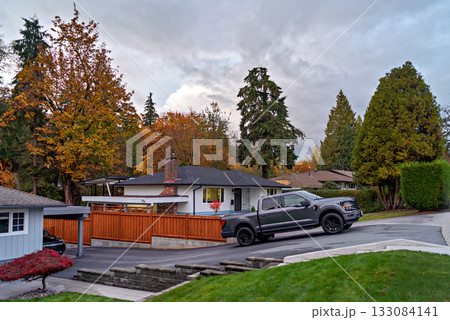 Autumn in residential area with a truck parked on uphil driveway 133084141