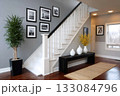 Modern home entryway with staircase and gallery wall 133084796