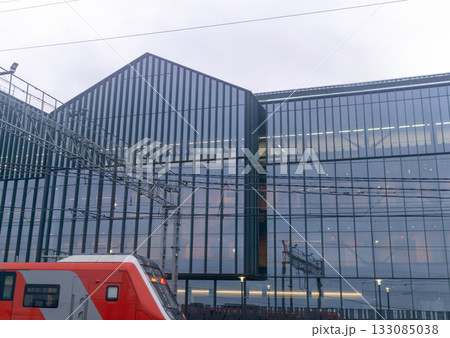 Modern high-speed train on a background of the modern building. Modern high-speed train on a background of the modern building. 133085038