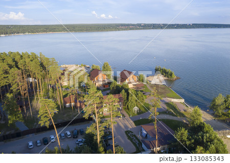 Aerial view of cottage village near the beach on the shore of the Ob Sea in Siberia in summer 133085343