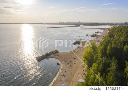 Aerial view of the beach on the shore of the Ob Sea in Siberia at sunset in summer 133085344