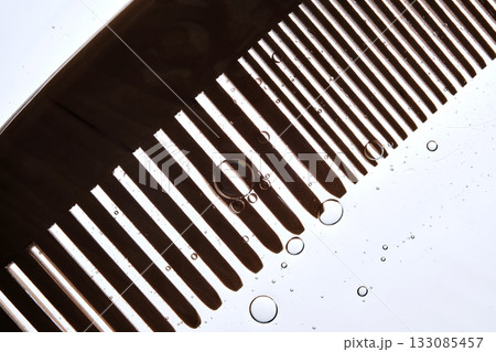 A comb with hair serum. The photo shows the texture of the cosmetic product. 133085457