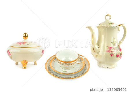 Vintage Porcelain Tea Set Elements with Gold Trim on White. 133085491
