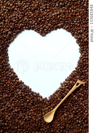 The coffee beans arranged in a heart shape on white background. 133085848