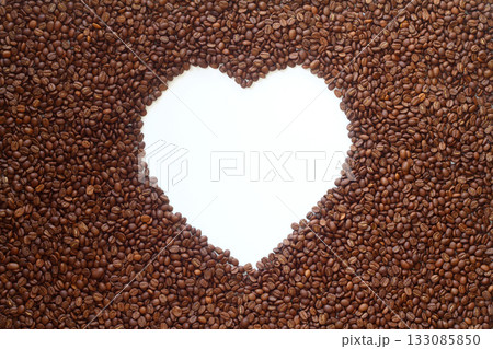 The coffee beans arranged in a heart shape on white background. The coffee beans arranged in a heart shape on white background. 133085850