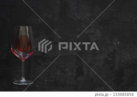 glass of red wine on black background. flat lay. 133085858