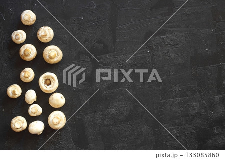 Flat lay composition with fresh wild mushrooms on black table Flat lay composition with fresh wild mushrooms on black table 133085860