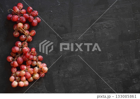 Bunch of fresh ripe juicy red grape flat lay on white background, copy space for text Bunch of fresh ripe juicy red grape flat lay on white background, copy space for text 133085861