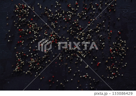 A mixture of peppers. Black, white, red polka dots. Isolated on a white background. 133086429